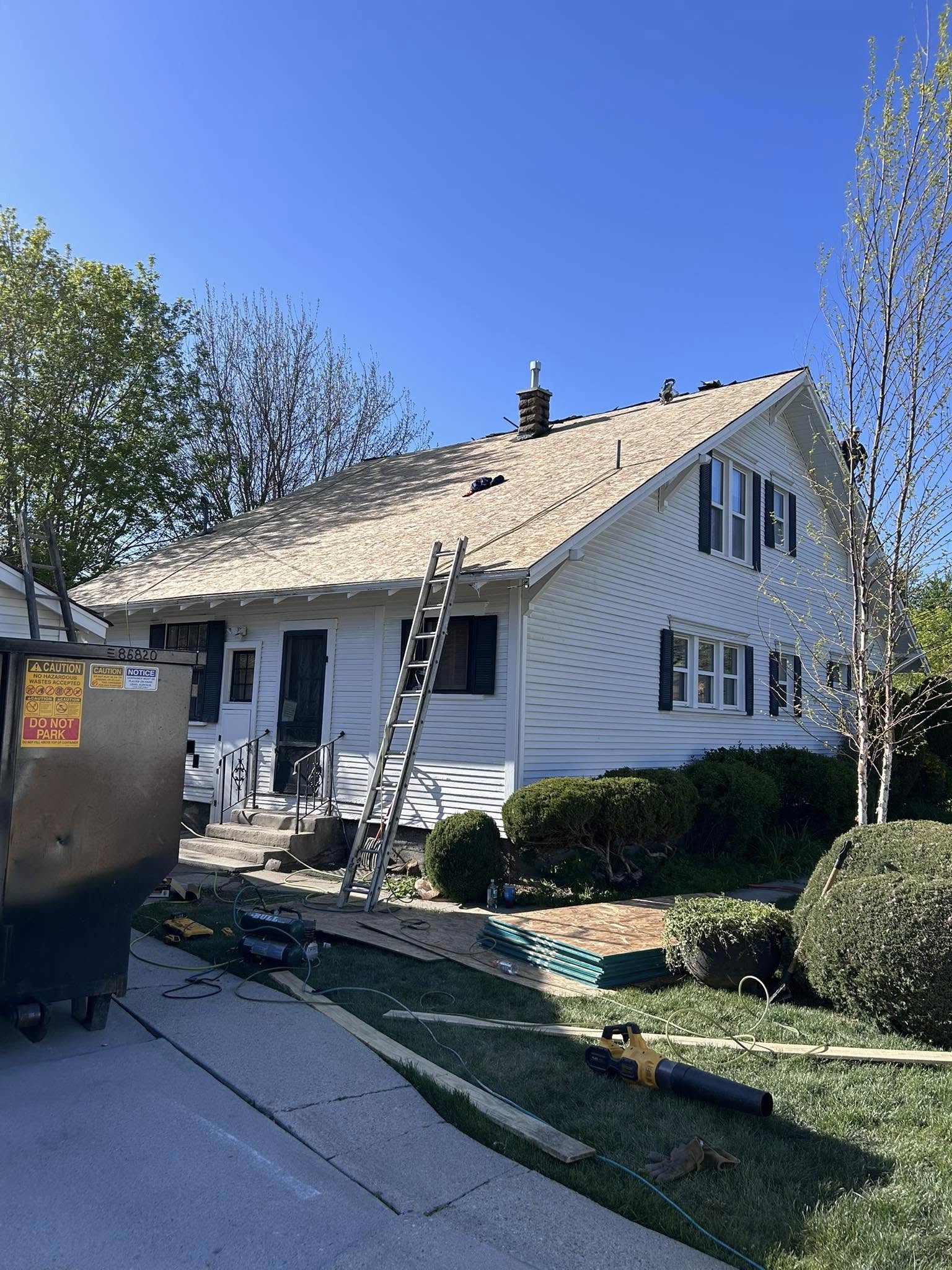work being done on a shingle roof